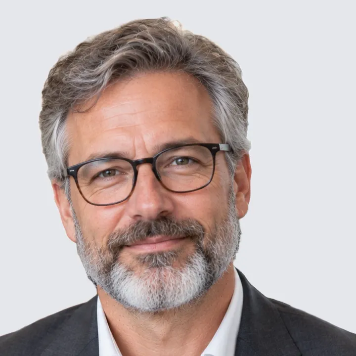 Gotowe zdjęcie profilowe LinkedIn: mężczyzna w okularach na gładkim jasnoszarym tle, głowa i ramiona